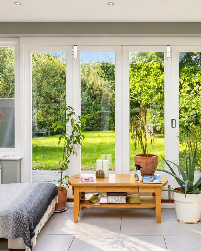 Timber bifold doors opening from a garden room onto the lawn, made by Spittlywood