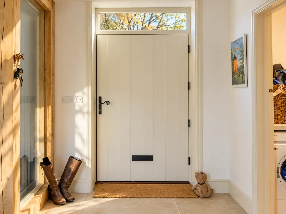Cream timber front door seen from inside a hallway, made by Spittlywood
