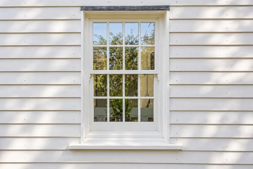 White timber sash window in a weatherboarded house, made by Spittlywood